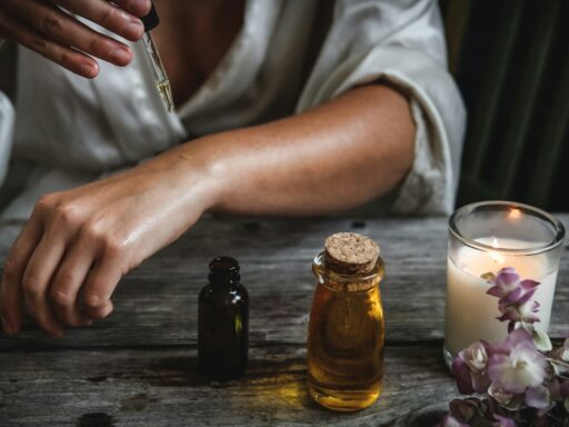 Person applying essential oil with dropper.