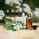 Aromatherapy oil bottle with flowers and dropper