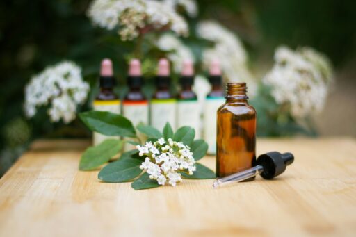 Aromatherapy oil bottle with flowers and dropper
