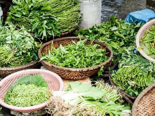 Baskets of fresh green vegetables at market