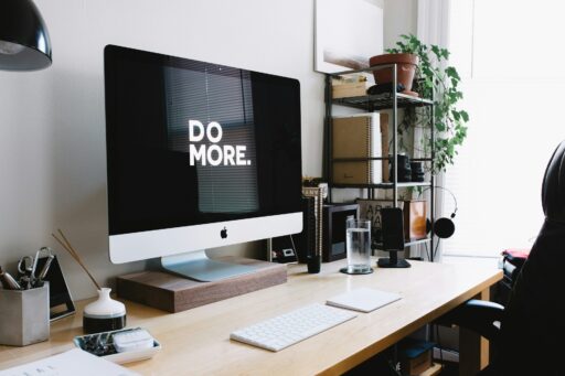Modern desk setup with 'Do More' on screen