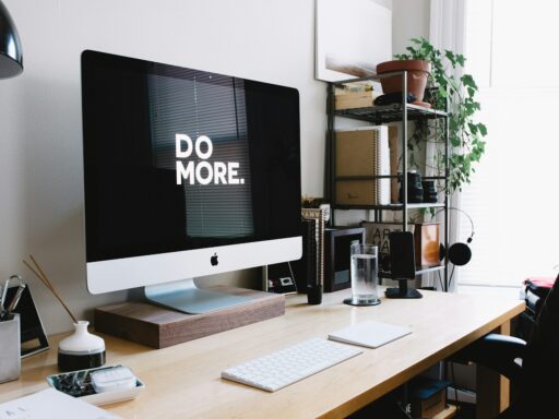 Modern desk setup with 'Do More' on screen